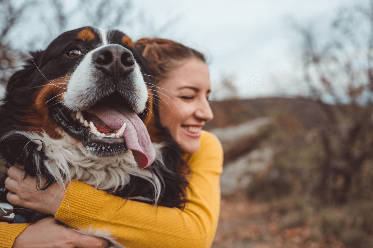 dog owner hugging her dog